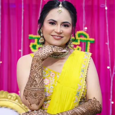 A stunning Mehndi bride ready for her ceremony. I created a fresh, dewy makeup look with pink tones and a neat updo to beautifully showcase her intricate henna and jewelry.