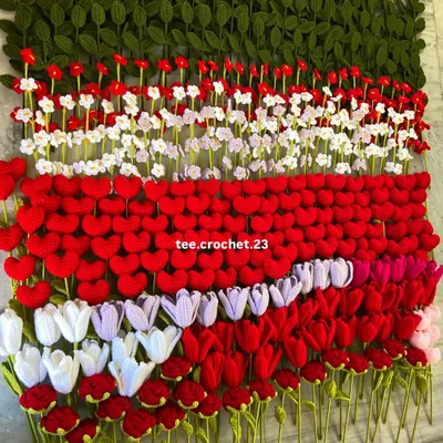 A massive wall of handmade crochet flower stems, showcasing the scale of my production for wholesale orders.