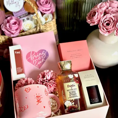 A luxury Mother's Day hamper to truly spoil her. This beautiful box includes a full-size Zara perfume, a Bath & Body Works shower gel, a Kay Beauty lip color, and a Marks & Spencer coffee mug and scented candle.