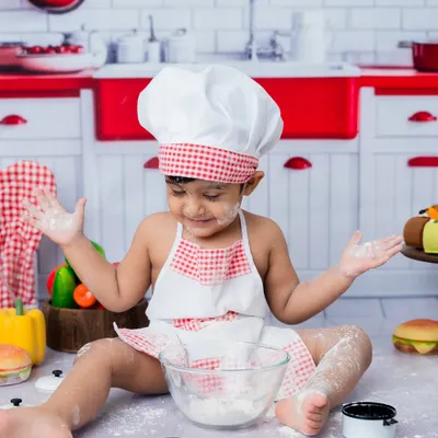 Getting messy is part of the fun in my toddler chef-themed photoshoots. This little baker is having a blast with the flour!
