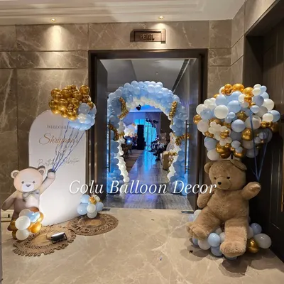 A grand entrance for a teddy bear themed first birthday, featuring a massive balloon arch and adorable bear props.