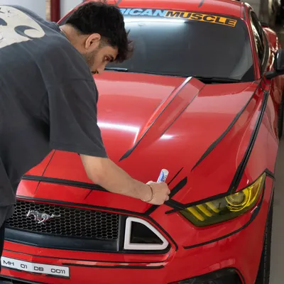 This was such a fun and challenging project. We gave this red Ford Mustang a "cartoon" or "borderlands" effect by hand-painting black comic-style outlines all over the car.