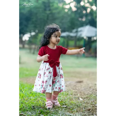 Two-year-old Riona exploring the park during her pre-birthday shoot. I encourage kids to move around and be curious, which allows me to capture natural, unposed photographs like this one.