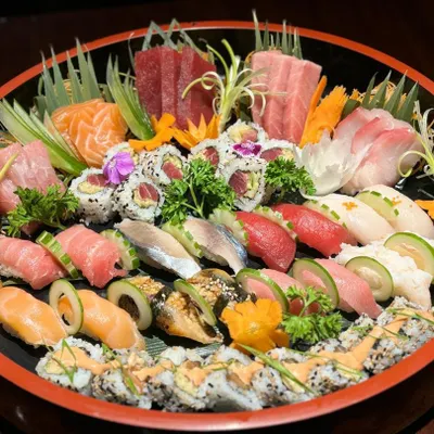 Our grand sushi and sashimi party platter. This is a true celebration of the sea, featuring a curated assortment of our finest tuna, salmon, and other seasonal fish, perfect for sharing.