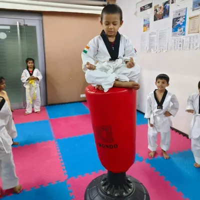 This is what dedication looks like. My 3.3-year-old student is practicing his focus and balance by meditating on top of the punching bag. Mental fitness, or *usko mental fitness bolte hain*, starts early here.