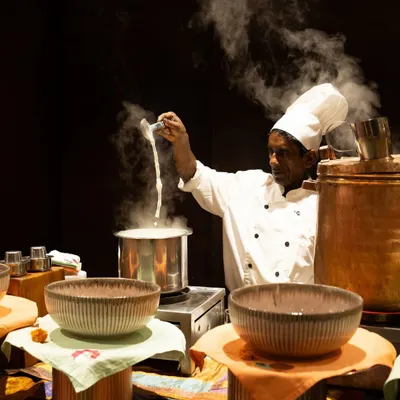 The dramatic pull of cheese from a freshly prepared dish at one of our live stations. This moment captures the heat, freshness, and culinary theatre that make our interactive counters a highlight of any event.