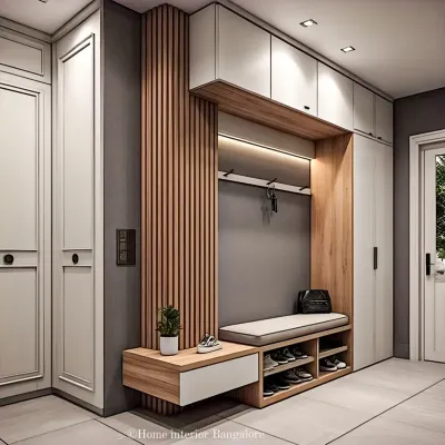 A complete entryway solution with floor-to-ceiling storage. This design features a comfortable seating bench, shoe cubbies, coat hooks, and overhead cabinets, all in a sophisticated grey and wood palette.