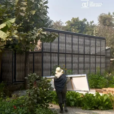 A view of the Artist Residency at Farm8, a project featured in The Architect's Diary. The design, nestled in nature, uses organic materials like bamboo screens and fire bricks to create a grounded sense of belonging for the artists who work here.