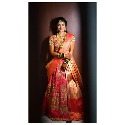 A complete bridal look for a client's special day. This custom half-saree lehenga combines a heavily embroidered blouse with a traditional skirt and dupatta, creating a regal South Indian bridal outfit.