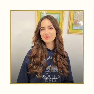 This look combines a soft, natural makeup application with beautifully styled bouncy curls. The makeup enhances her youthful glow with a hint of colour on the cheeks and lips, creating a fresh and radiant appearance.