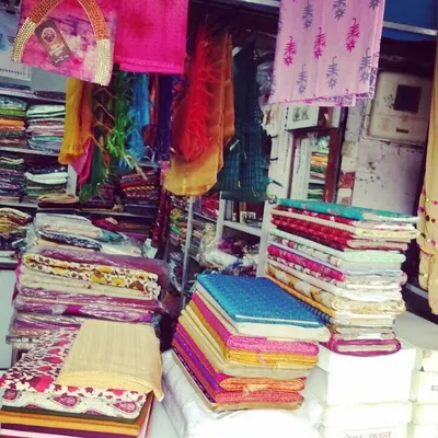 A glimpse into my workshop where I keep a wide variety of fabrics. You can choose from my collection or bring your own material for stitching.