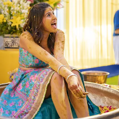 The bride's priceless reaction during her fun-filled Haldi ceremony in Delhi. The joy is just bursting out of this photo.