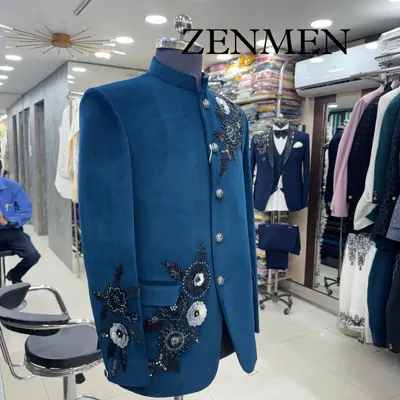 A glimpse of my teal velvet Jodhpuri suit on display in the studio. You can see the racks of fabrics and other designs in the background, showing the variety I offer.