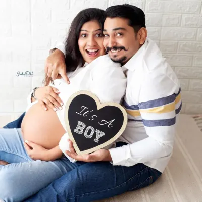 Such a fun and happy announcement! This couple's excitement is contagious, and the "It's a Boy" sign is a perfect prop for sharing their joy.