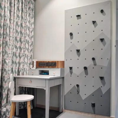 To encourage active play, I designed this custom climbing wall for a toddler's room. It's a safe and fun way for kids to develop motor skills and burn off energy indoors.