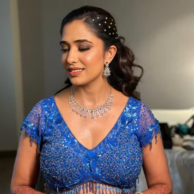 This modern and chic ponytail is adorned with scattered pearls, adding a touch of glamour and sophistication. It's the perfect hairstyle to show off an intricate neckline and statement earrings.
