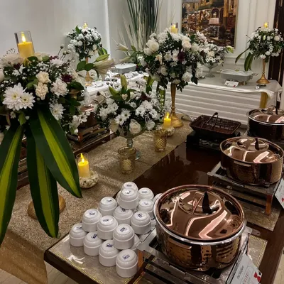 An elegant buffet setup for an intimate gathering at home, featuring my signature copper serveware and beautiful floral arrangements.
