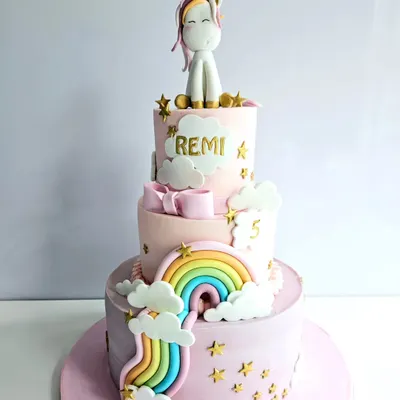 This three-tier unicorn cake is a dream come true for any magical party. It features soft pastel pink frosting, a cascading rainbow, fluffy clouds, and a cute unicorn topper, all made to create a whimsical birthday celebration.