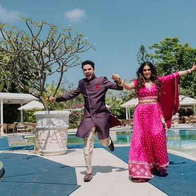 Pure, infectious energy from a couple running by the pool. This shot is all about fun and matching each other's vibe, creating a perfect memory of their engagement celebration.