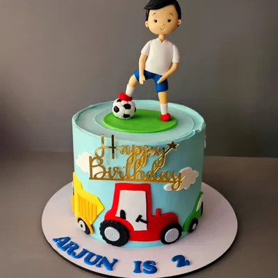 Look at that swag! A cake for Arjun's 2nd birthday, featuring a little boy with a football and his favorite trucks. A perfect cake for a toddler who loves to play.