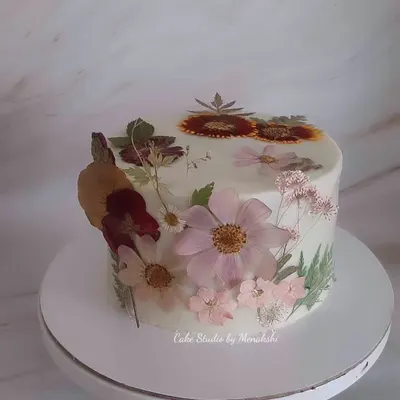 One of my prettiest cakes, adorned completely with hand-pressed, dried natural flowers. Each delicate flower was carefully placed to create this stunning, botanical work of art on a no-fondant cake.