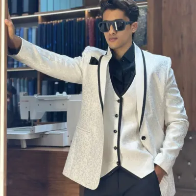 This white textured three piece tuxedo with black satin piping is the definition of modern elegance. It's designed for grooms and guests who want a sharp, sophisticated look for a wedding or reception.