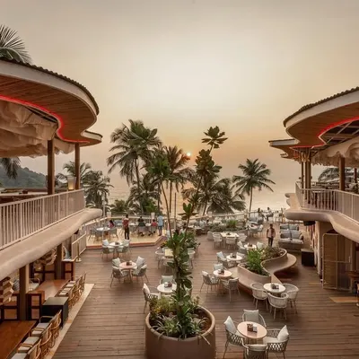 An expansive view of Dubki in Goa at sunset, a project designed to blend seamlessly with its cliffside location by Ozran beach. The multi-level layout and flowing roofline provide every guest with a breathtaking ocean view.