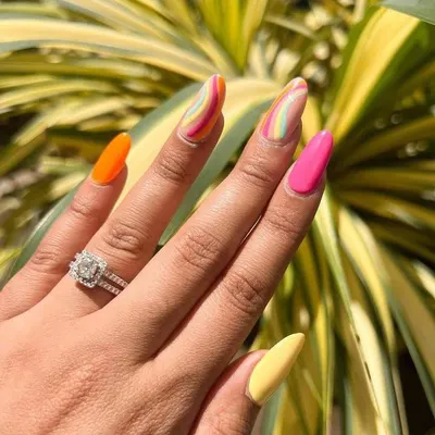 I can’t stop fussing over these gorgeous summer nails. This set features a mix of bright solid colors and abstract rainbow wave art.