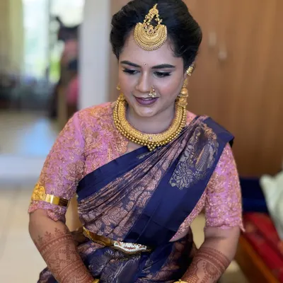 The beautiful Gowthami, looking absolutely breathtaking for her son's naming ceremony. We chose a classic South Indian look with a silk saree, temple jewelry, and a traditional hair bun.