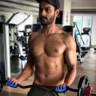 Staying strong and focused in the gym. Here I am working on my physique with an EZ bar curl, because I live the fitness lifestyle I advocate for.