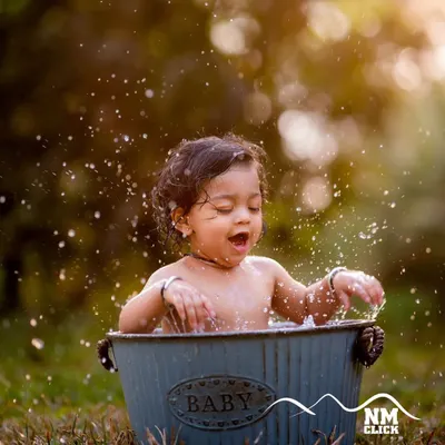 The magic of a golden hour bath session. The warm light and happy splashes combine to create a truly breathtaking and joyful portrait.