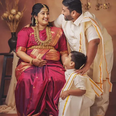 A beautiful family portrait celebrating their next chapter. The mother-to-be looks radiant in her silk saree, and the way her husband and son look at her is full of love and excitement.