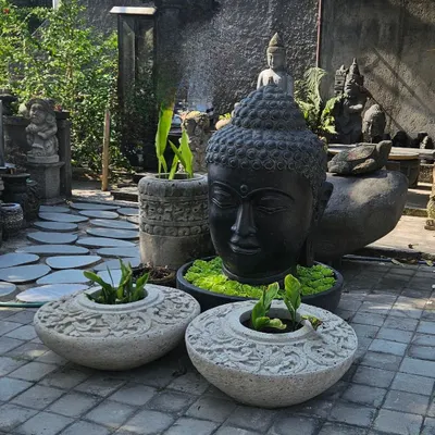 Our search for unique decor takes us to faraway places. Here is a collection of hand-carved stone planters and a large Buddha head, perfect for creating an authentic Balinese-style garden.