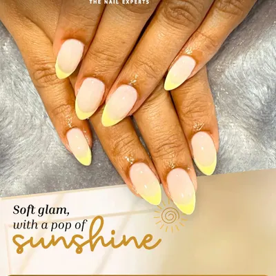 Soft glam with a pop of sunshine. This is a modern take on the French manicure, featuring a soft nude base and cheerful, pastel yellow tips for a fresh and subtle look.