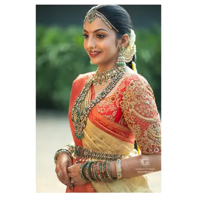 A beautiful side profile of my bride Likitha, showcasing the harmony between her makeup, the intricate embroidery of her blouse, and her stunning emerald and polki jewelry. This is the essence of a complete, regal bridal look.