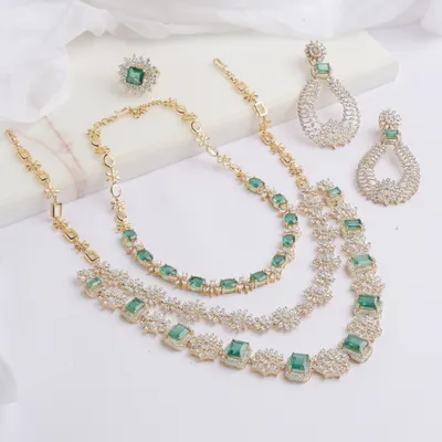 The complete Heera Panna set, a celebration of emeralds and diamonds. This versatile suite includes a double layered, detachable necklace, a magnificent cocktail ring with a 5 carat Ascher cut emerald, and matching teardrop earrings.