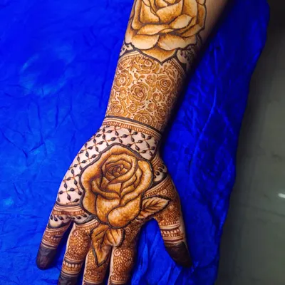 A design where I blended contemporary and traditional styles, featuring a large, realistic rose on the arm and hand, contrasted with delicate traditional patterns.