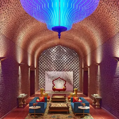 The lobby of Taj Devi Ratn, designed to be a modern palace. The vaulted ceiling with intricate latticework and the dramatic blue chandelier create a breathtaking welcome, setting the tone for a stay steeped in luxury and Rajasthani heritage.