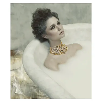 This image is from my "Sculptured Portraits" series, where I explore the intersection of art and photography. The concept was to treat the subject like a classical sculpture, using the milky bath to create texture and the exquisite jewelry as the focal point. It's about creating a timeless piece of art.