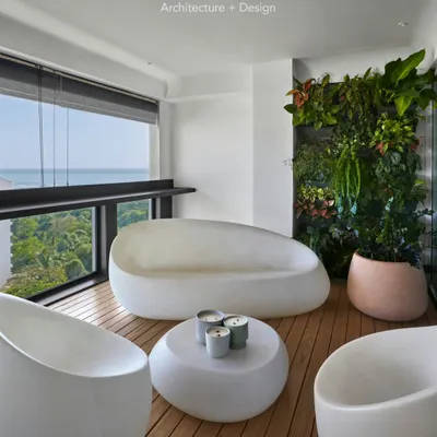 The deck एरिया of Project 86. We created a relaxing outdoor lounge with a vertical garden, wooden floors, and backlit Vondom furniture. It's the perfect spot for a sundowner with a view of the ocean.