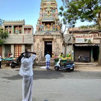 A man prays before a temple in Tiruchirappalli. The spiritual life of a city is deeply embedded in its physical form, a connection I seek to honor in my work.