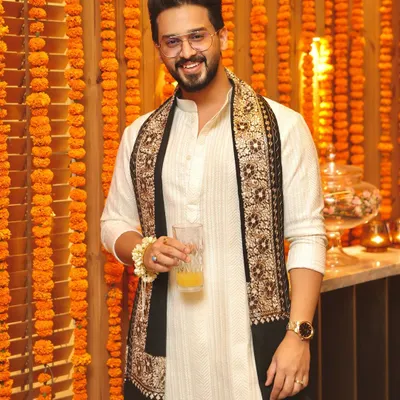 Wishing everyone a Happy Diwali! This client celebrates the festival of lights in a custom off-white kurta paired with a stunning black stole featuring intricate traditional embroidery.