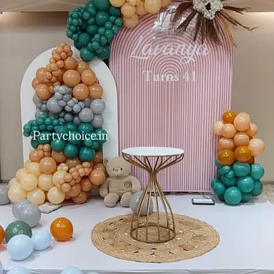 A closer look at the modern boho-chic decor for a 41st birthday, showing the texture of the balloons and the elegant cake table.