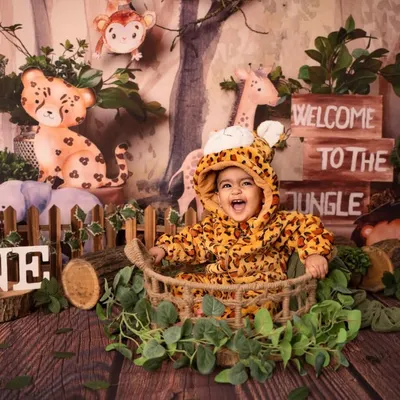 Welcome to the jungle! This little explorer is having a wild time in our jungle-themed first birthday setup, complete with adorable animal friends and lush greenery.
