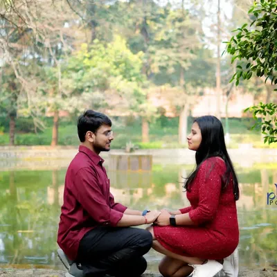 A candid shot of the couple facing each other by the lake at Lodhi Garden. This natural, unposed moment captures their genuine connection and the serene park atmosphere.