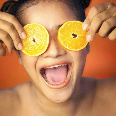 A fun and quirky shot for a beauty or food campaign, using fresh oranges to create a playful and eye-catching image. This is great for social media advertising.