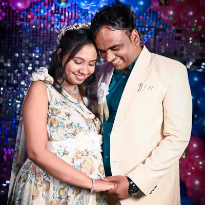 A sweet, candid moment between the expecting couple at their baby shower. Their happy smiles and gentle hold show the excitement and love that filled the room during their celebration.