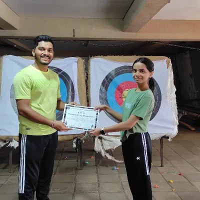 Another happy student from our July Basic Archery Course receiving her certificate. It's a proud moment for both the archer and the coach.