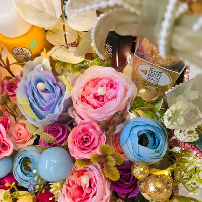A close up of a vibrant and overflowing birthday hamper. This one was for a 30th birthday, featuring 30 beautiful blooms mixed with skincare goodies and chocolates.
