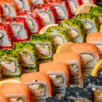 A colorful and enticing platter of assorted sushi rolls. We offer a wide variety of options, including salmon, tuna, and vegetarian rolls, all freshly prepared to provide a taste of Japanese culinary art.